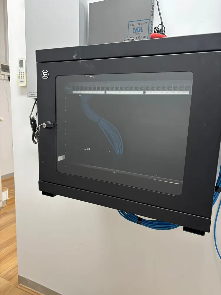 Closed, lockable wall-mount data cabinet with a glass door